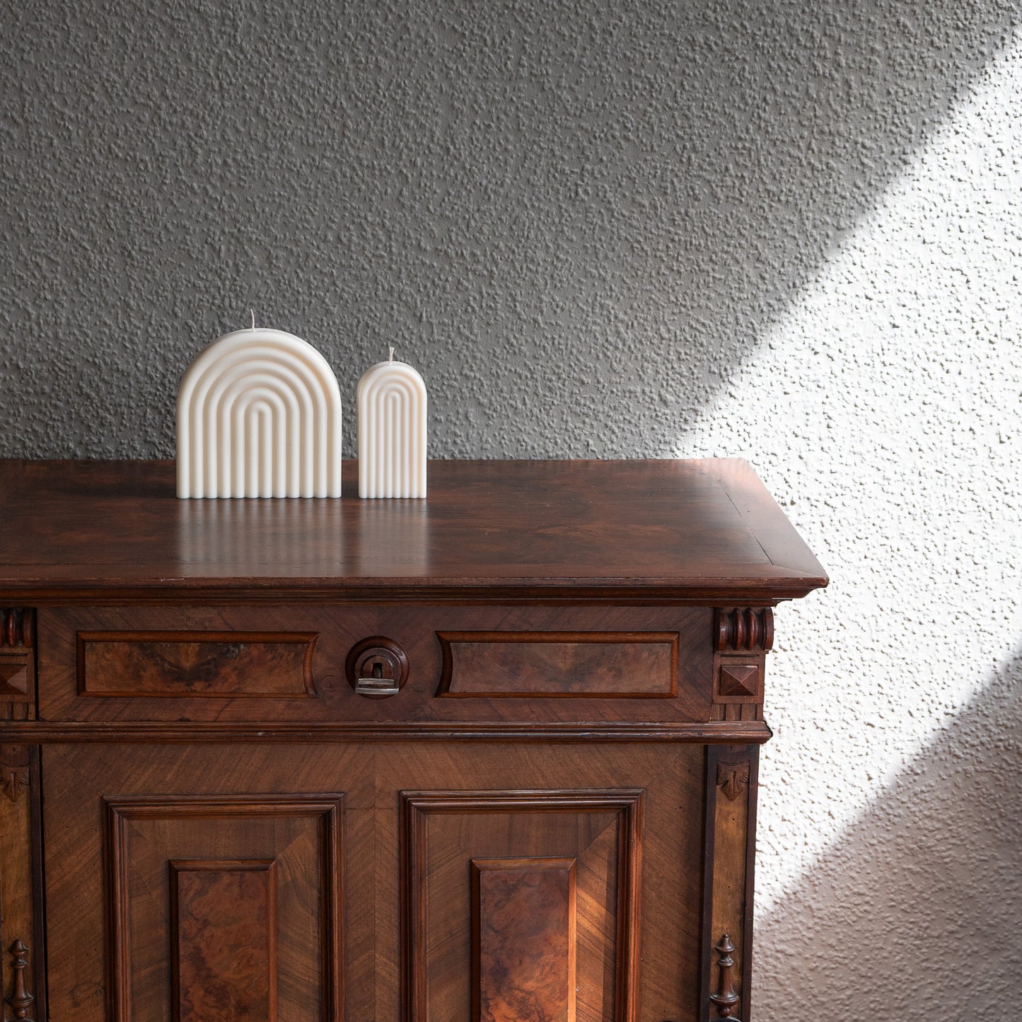 Kerzen Set Farverig in natürlichem Cremeton – skulpturale Regenbogen Designkerzen, Rapswachs, handgefertigt in Hamburg, 100 % pflanzlich & nachhaltig. Studio Z. Dekoriert auf barockem Tisch im Schatten-Lichtspiel der Sonne mit Vase.